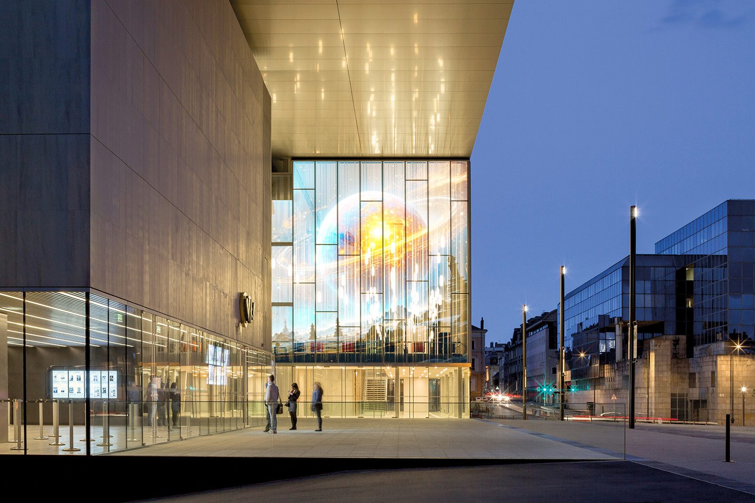 Glass curtain-wall facade at dusk with holographic LED content integrated flush with the glazing